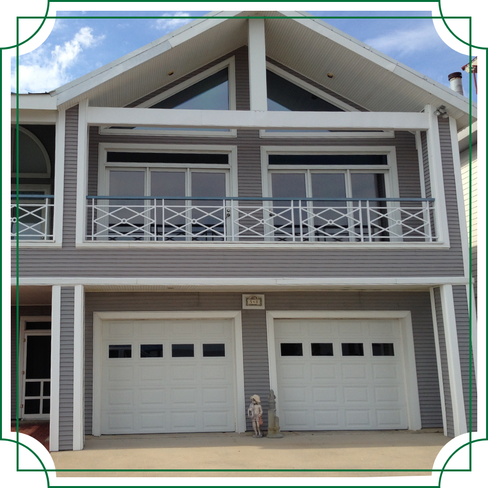 front of home with large glass windows on second floor