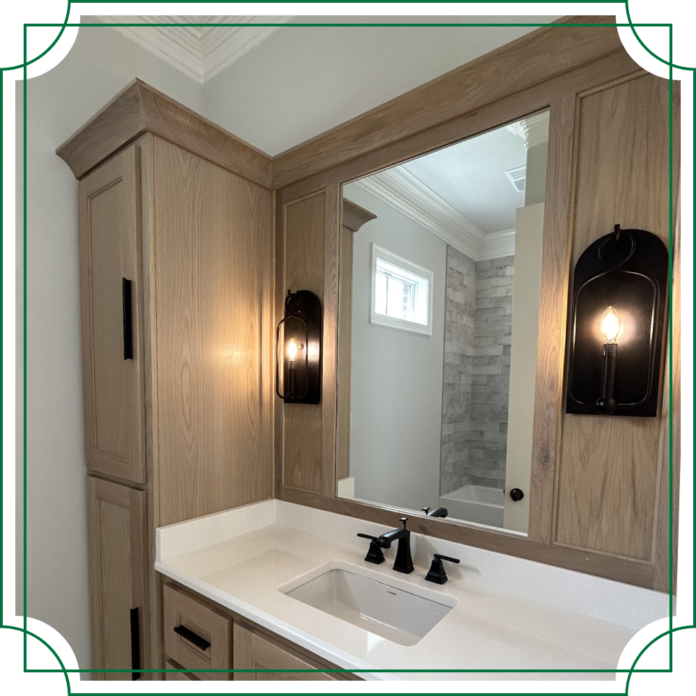 mirror with sconces surrounded by custom wood cabinets