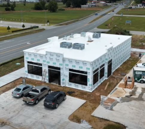drone shot of building undergoing professional window installation
