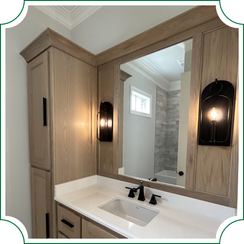 mirror with sconces surrounded by custom wood cabinets